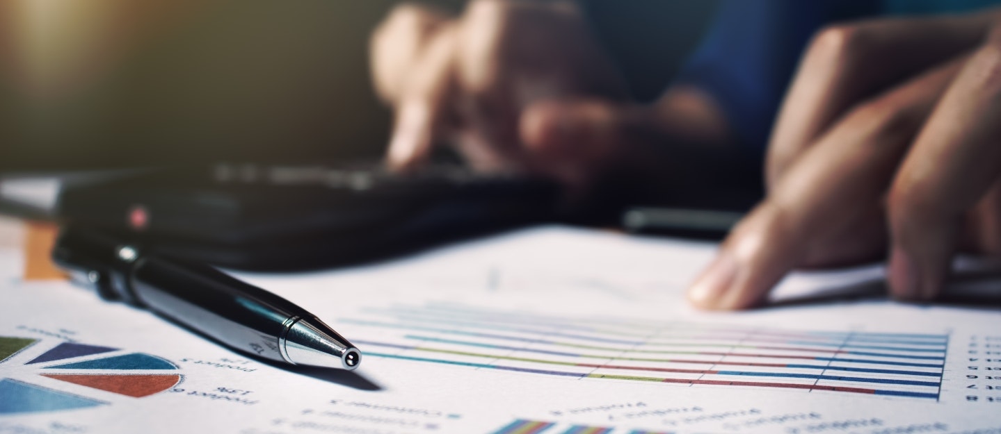 Close up pen on paperwork and woman hand calculate finance.