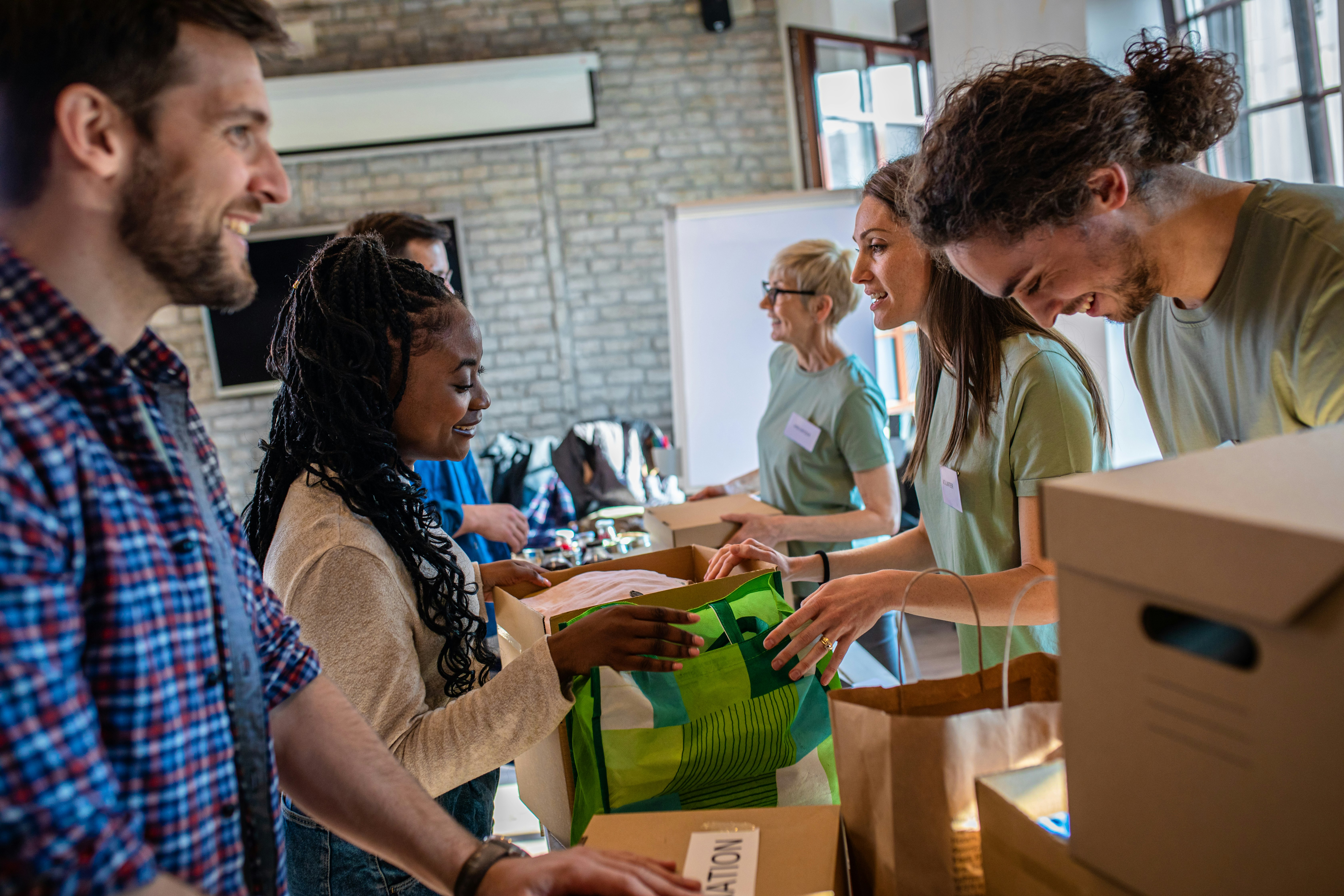 Group of people work on collecting donations in a community room.