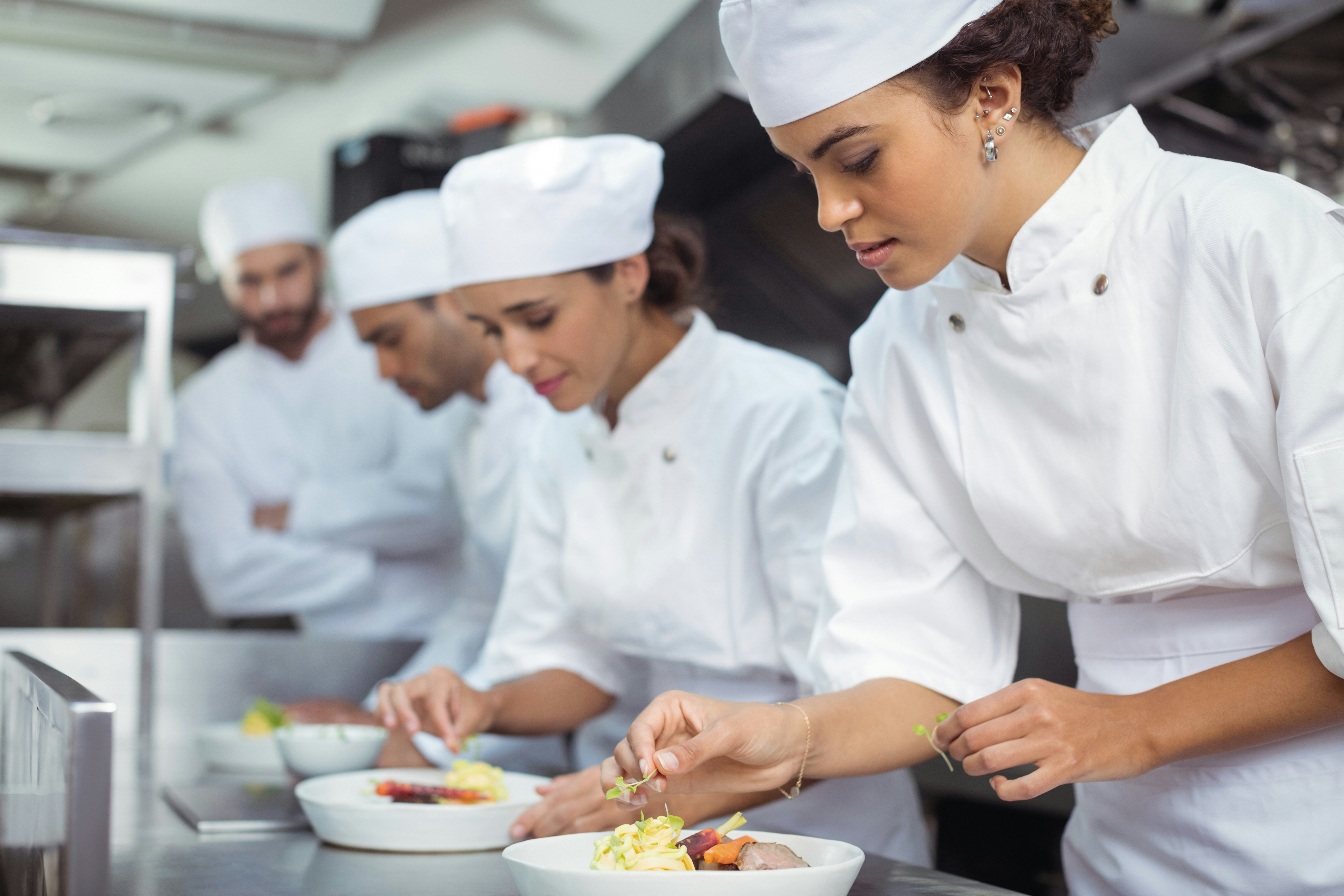 Women chefs plating meal