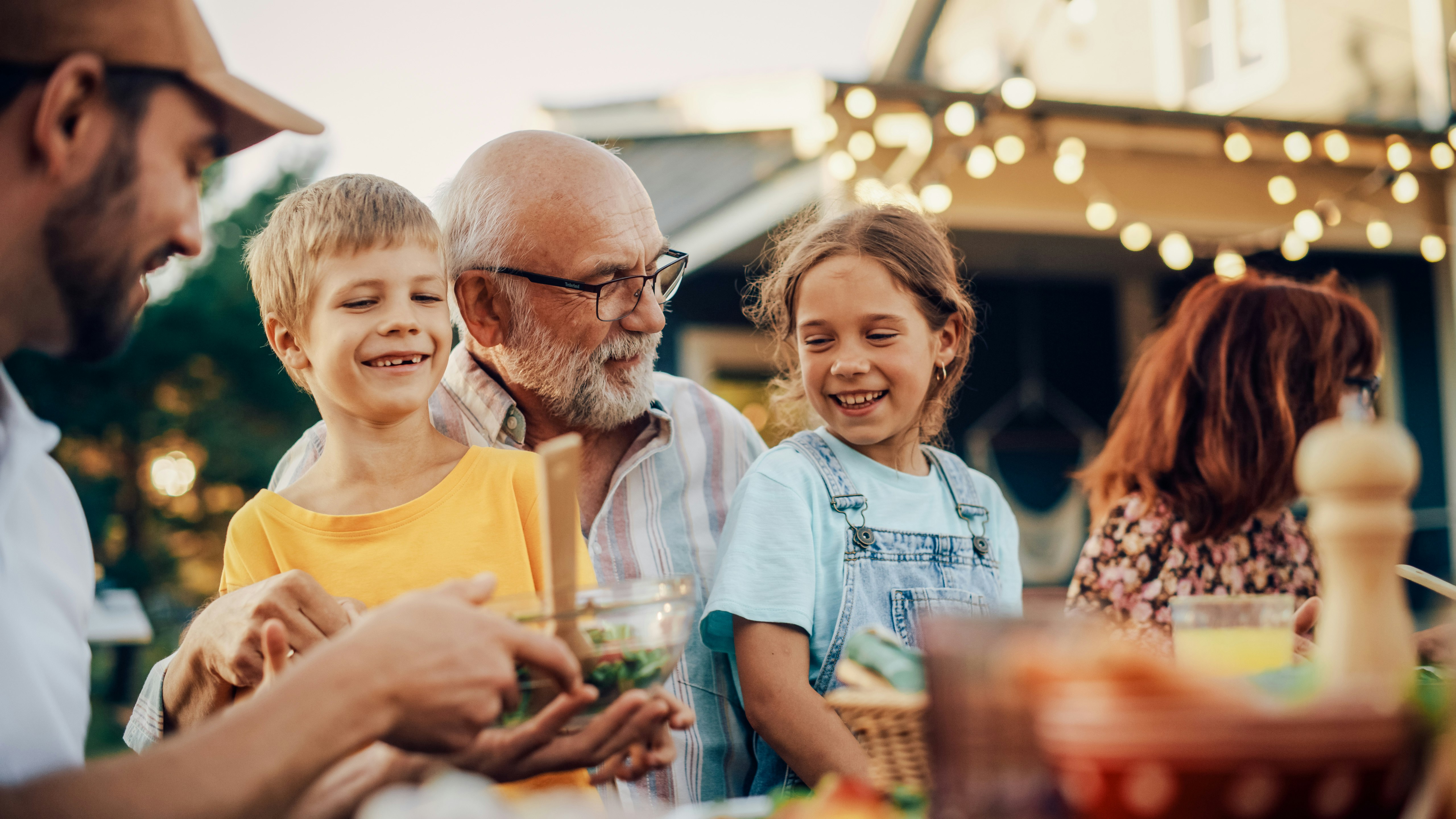 Talking to your children about money Happy grandfather talking and having fun with grandchildren.