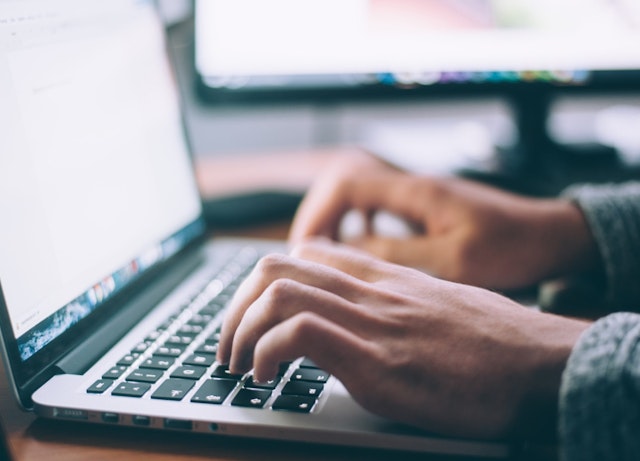 Hands on laptop keyboard