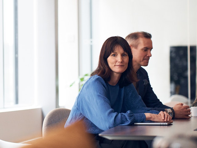 Woman and man sitting by a desk