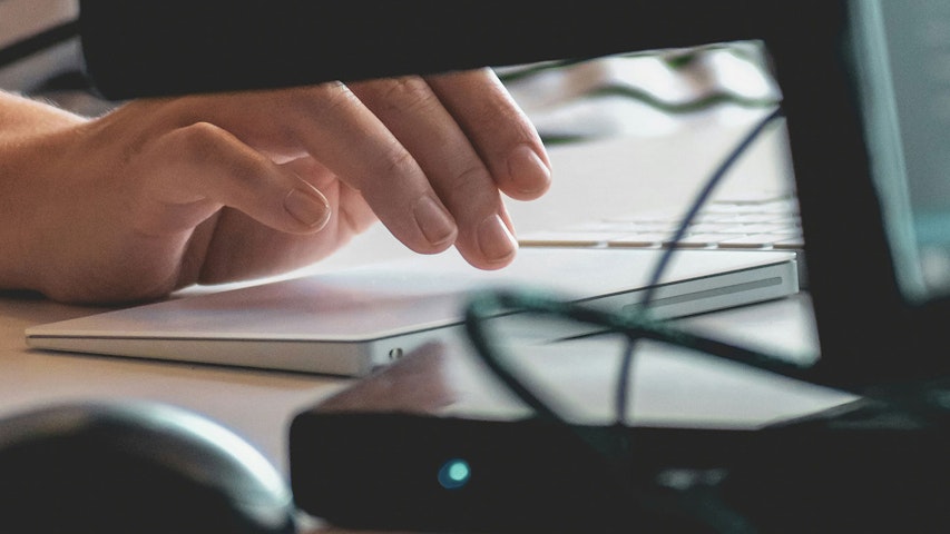 Hands writing on keyboard