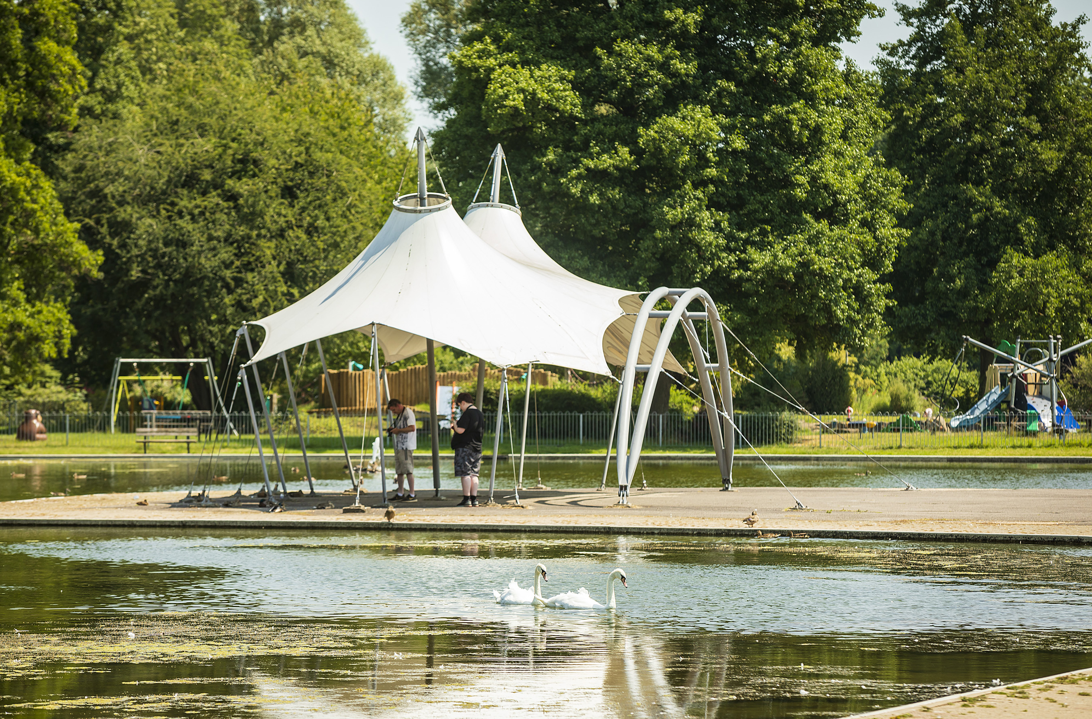 The bandstand of Eastrop Park is in the middles of the image. In front of it is the lake and behind you can see the playground and trees.