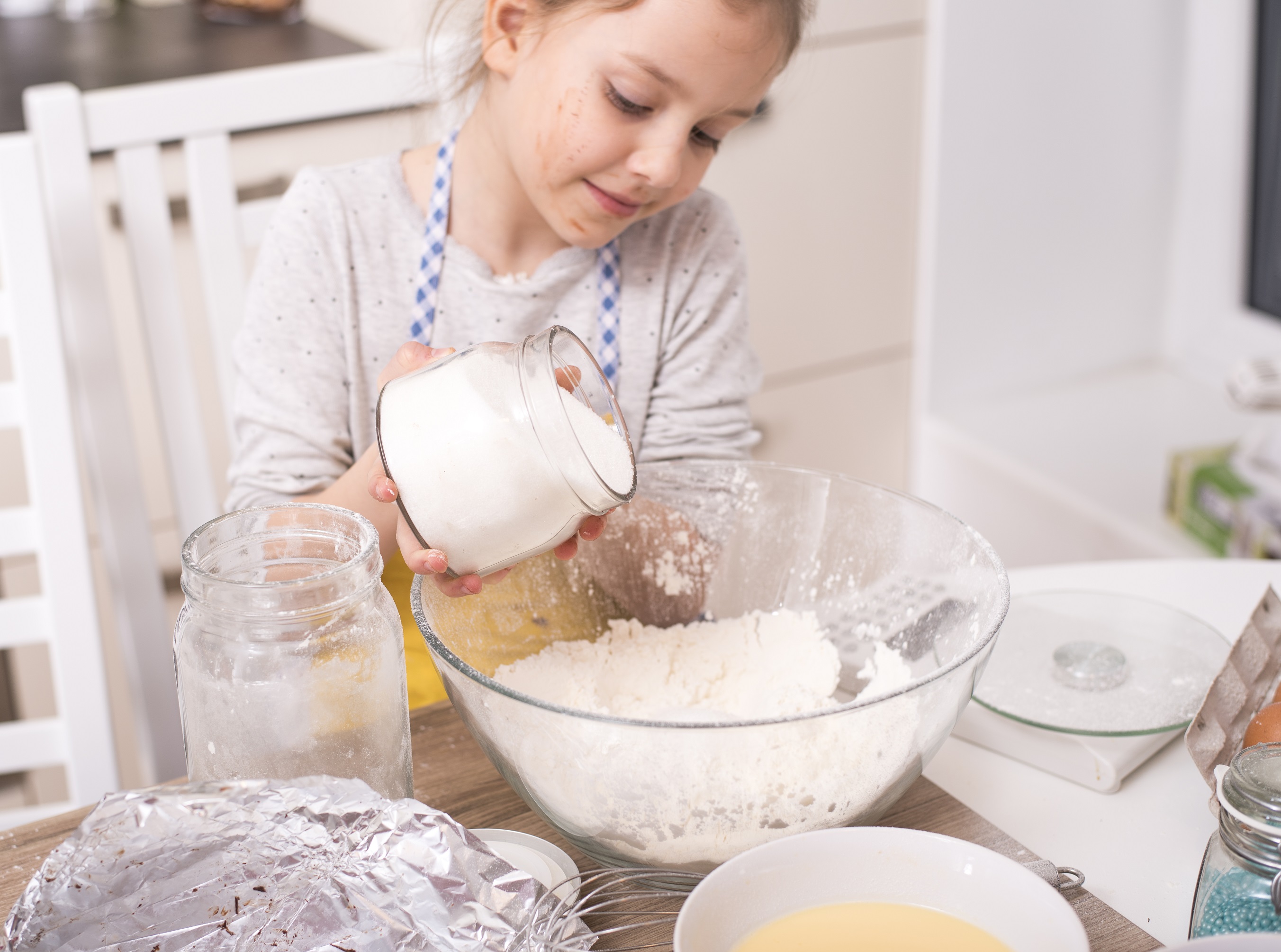 A young girl making dessert