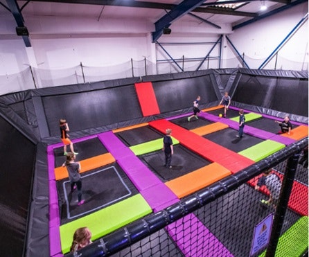 People stand in the middle of trampolines