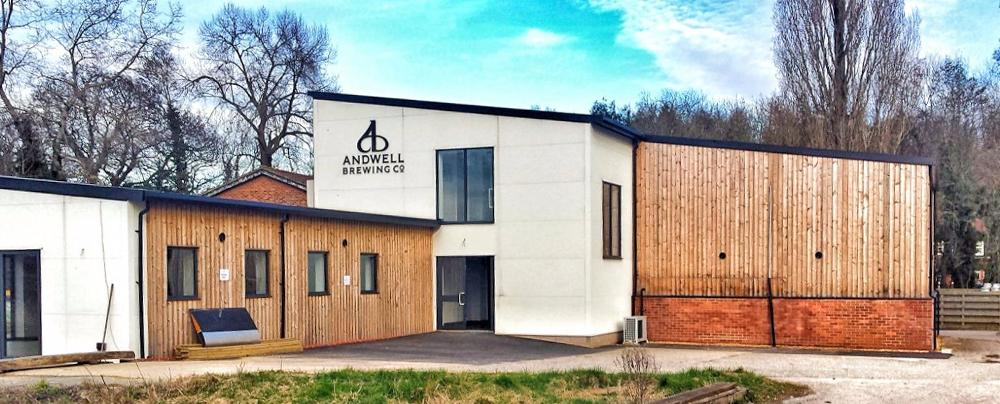 A timber and white render building with the Andwell Brewing Co. logo on the side.