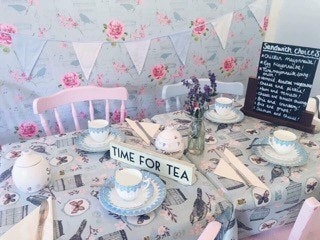 Afternoon tea displayed on a floral tablecloth