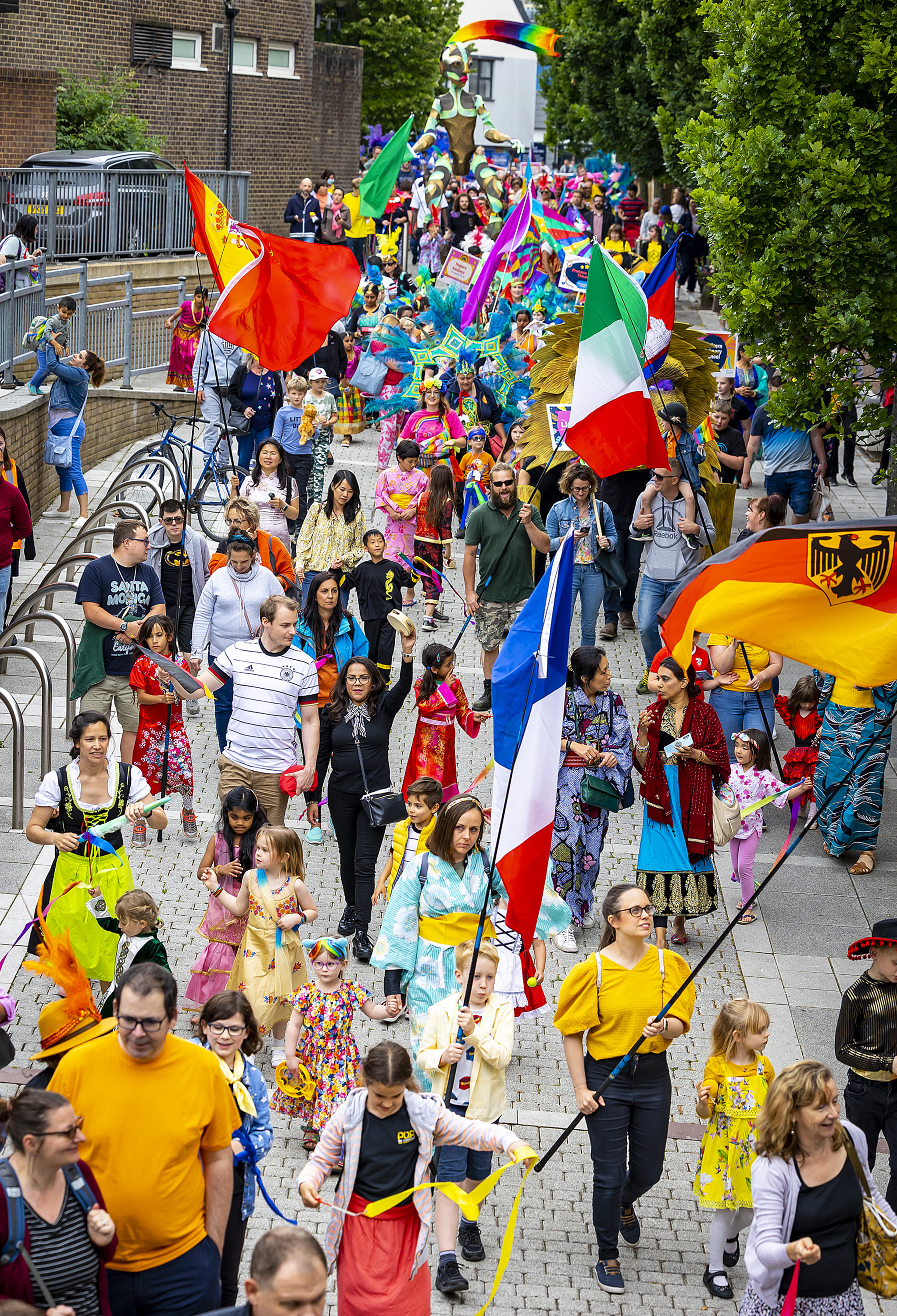 A group of people holding flags from different countries parade through Basingstoke