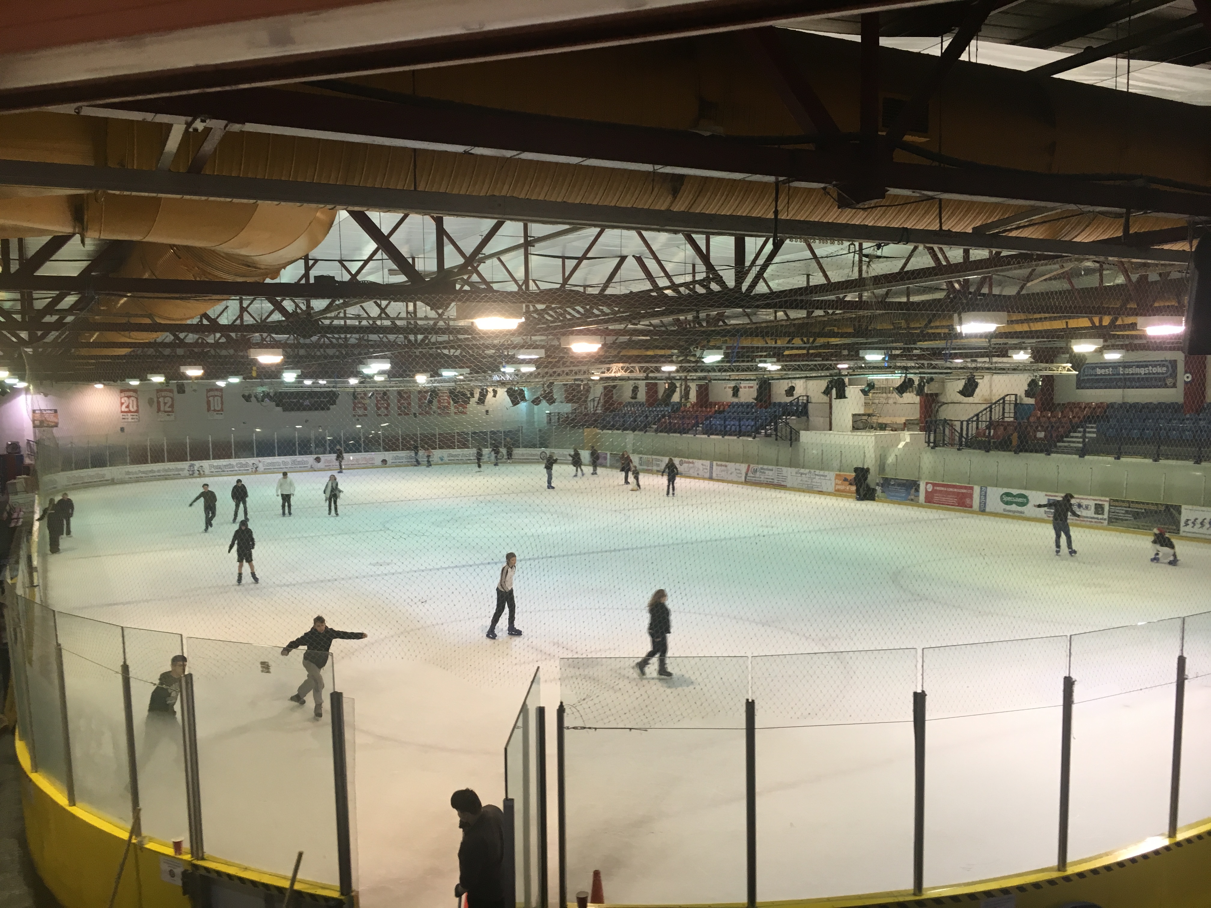An indoor ice rink with people skating
