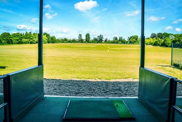 A driving range. You can see a bay with a green space in front.