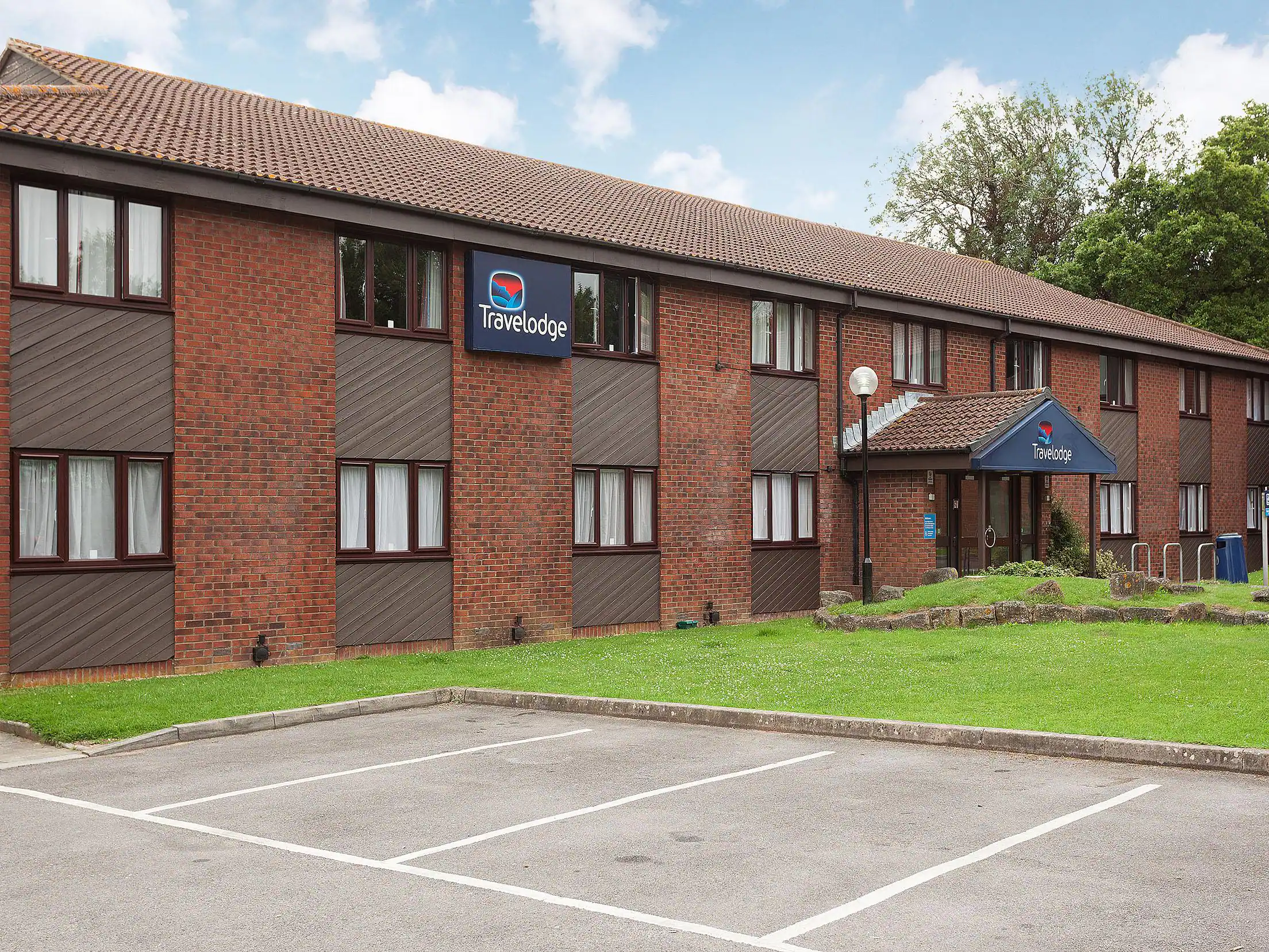 A two storey red brick building with a brown tiled roof.