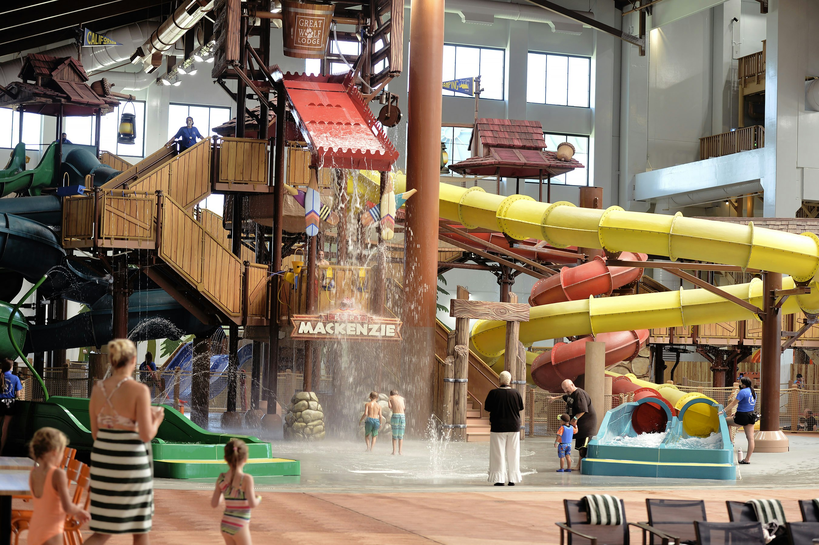An indoor water park. You can see flumes and step and water coming out of a bucket