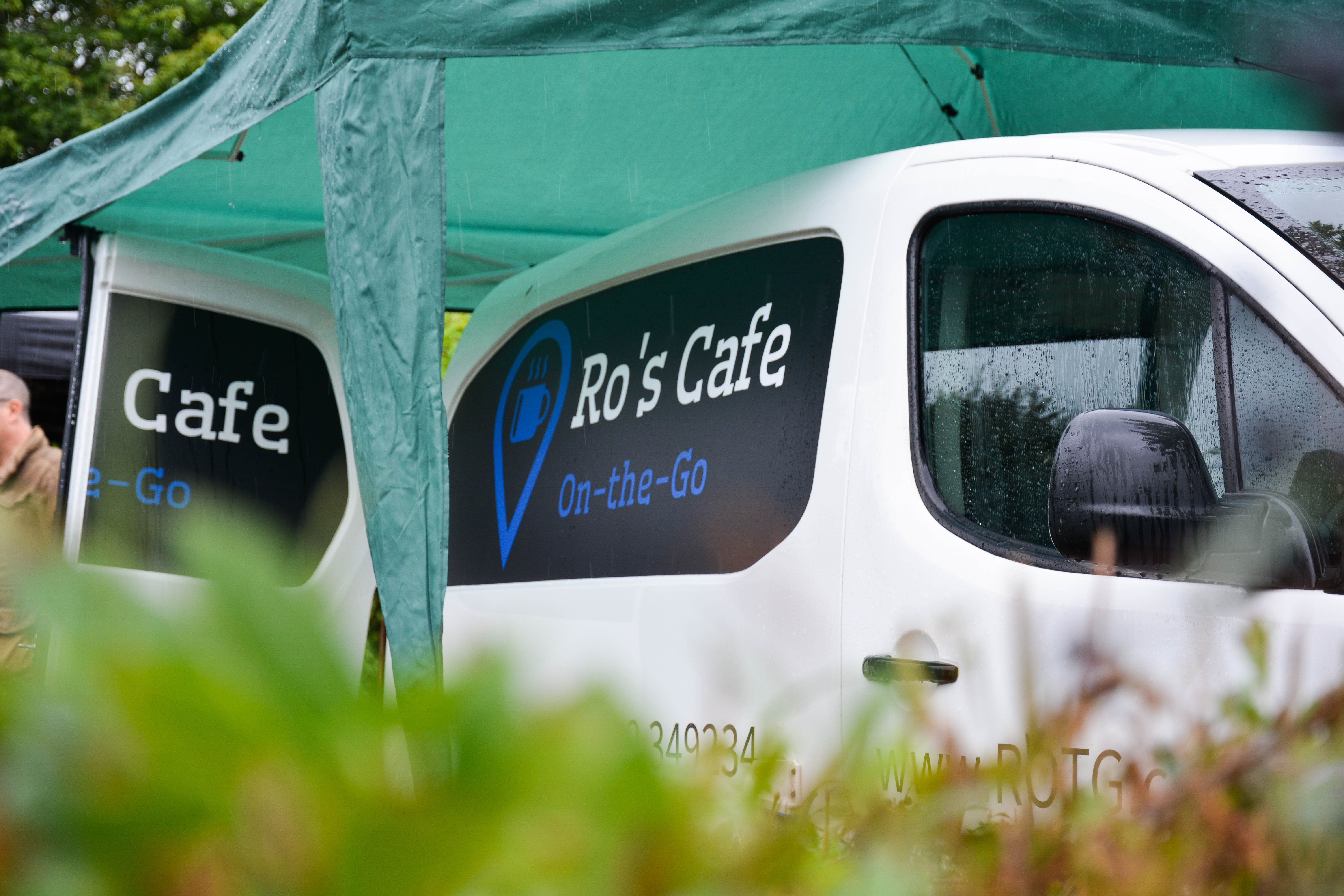 A white van and green gazebo