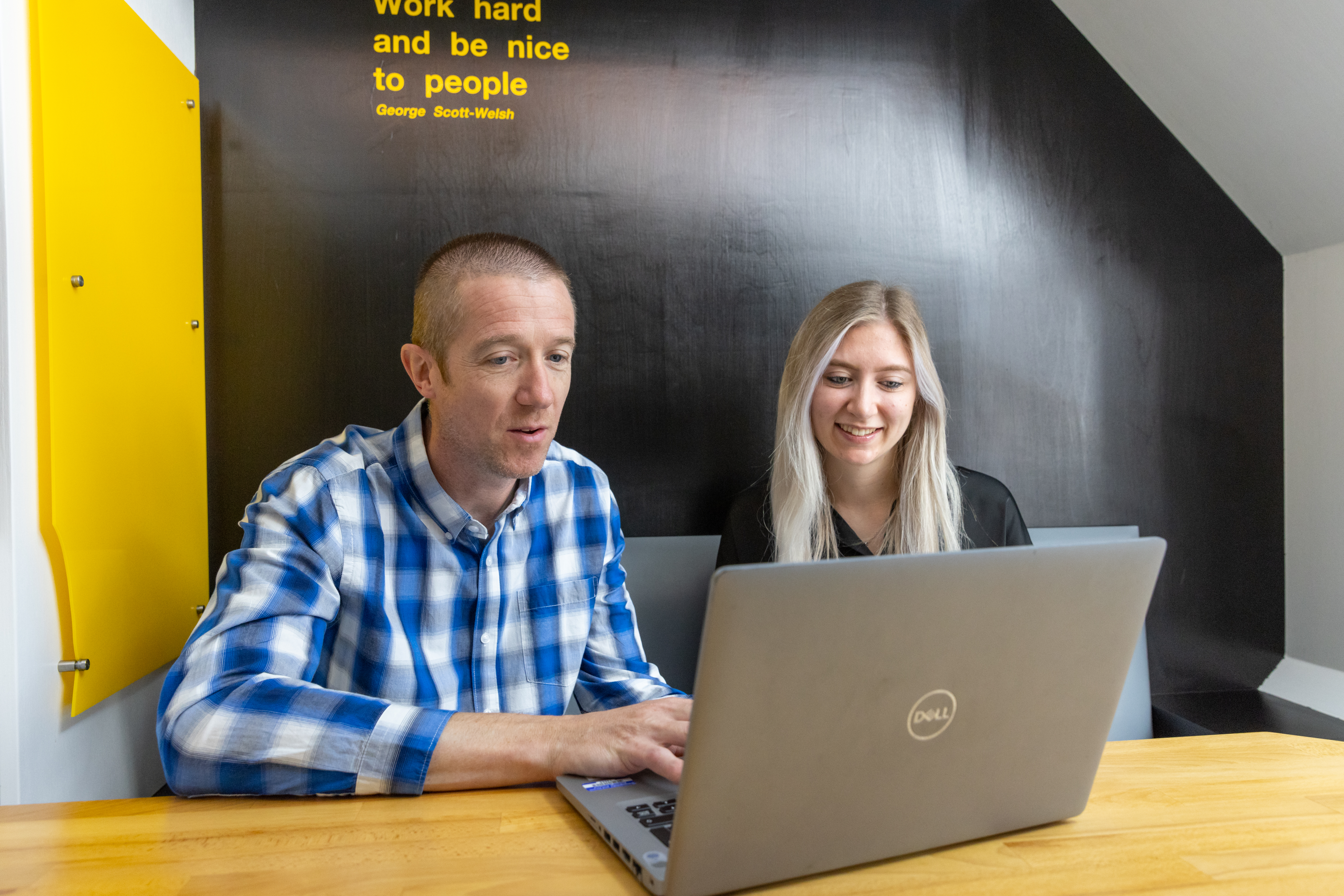 Two people in front of a computer