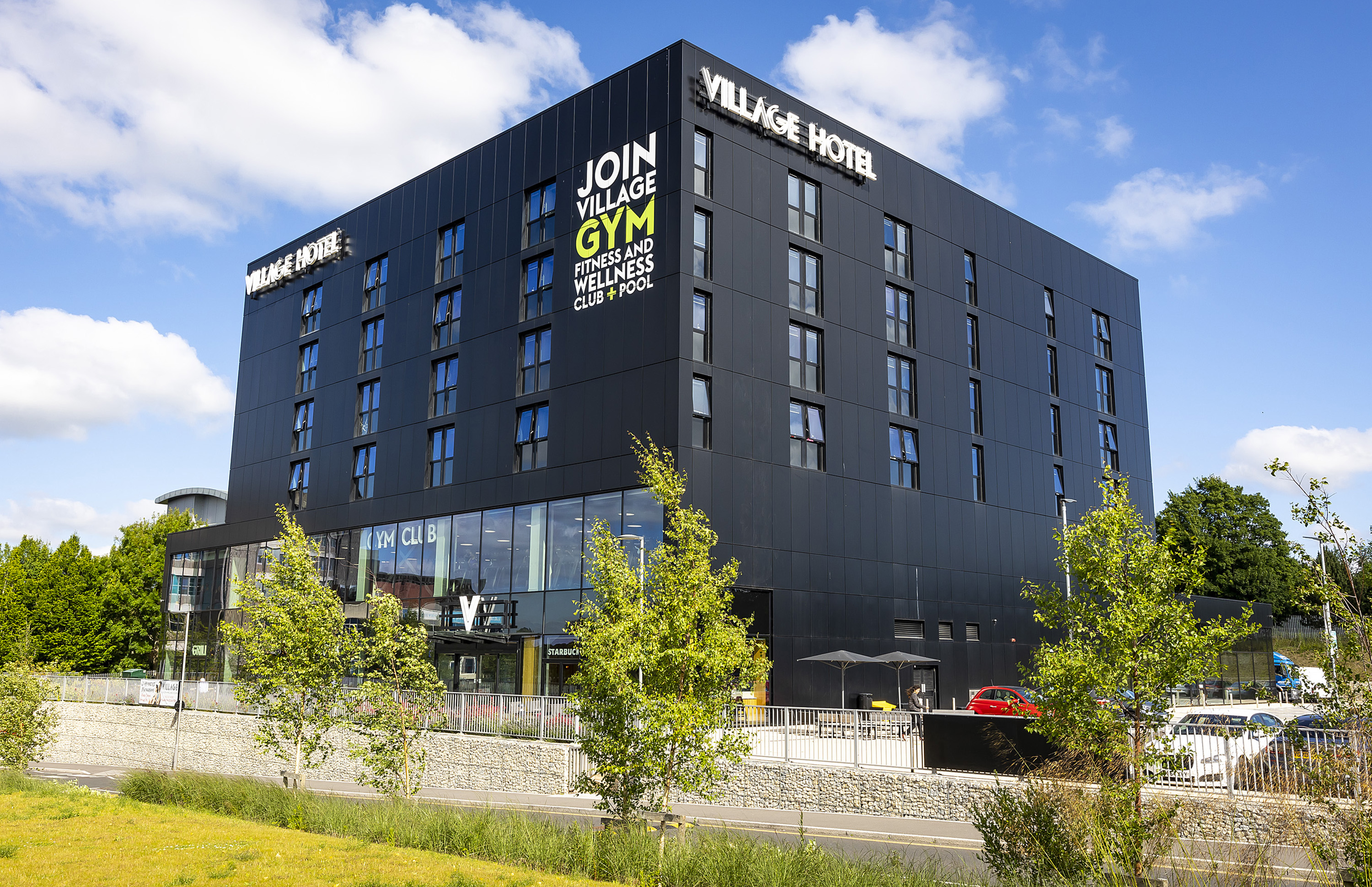 A black building with glass front.