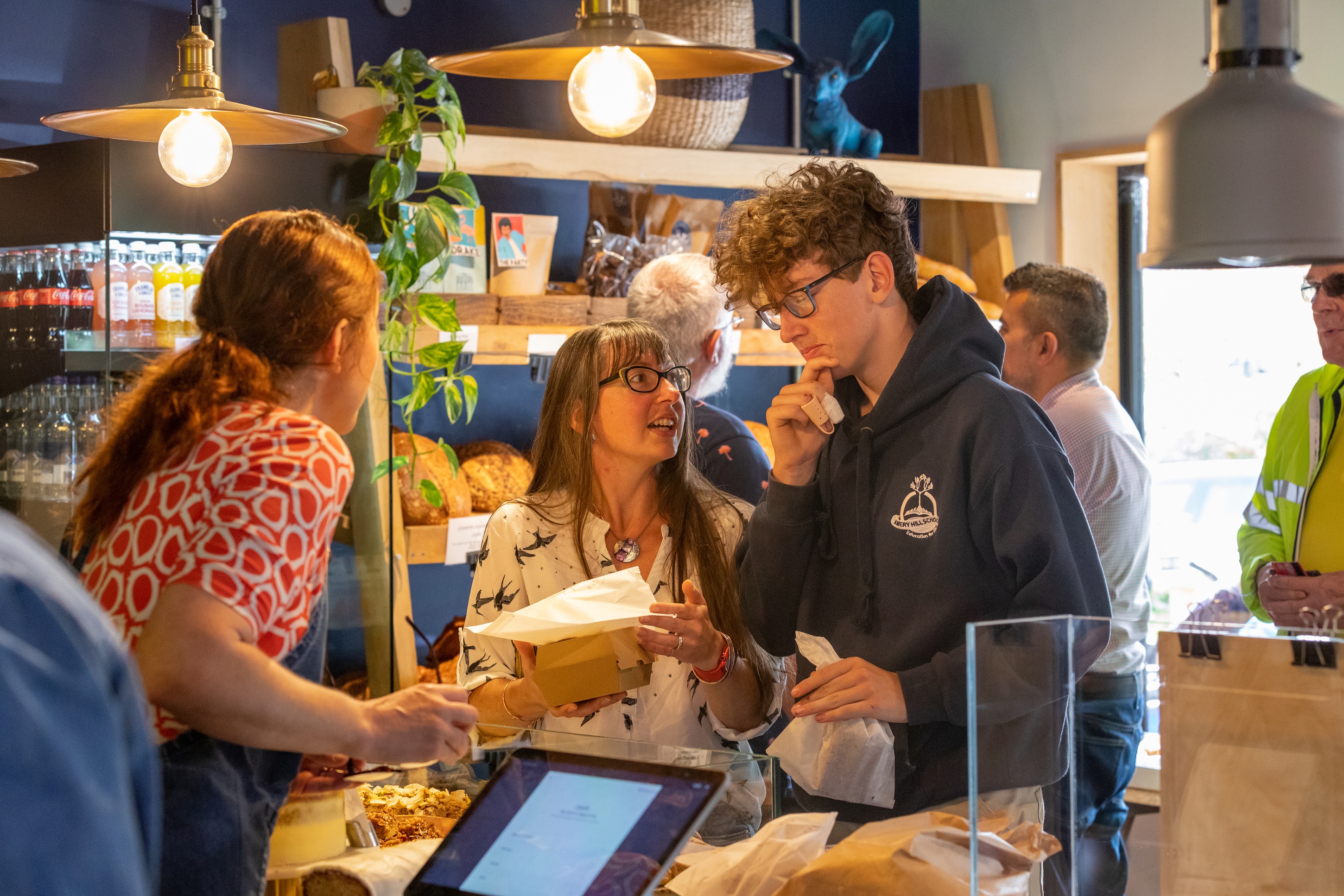 Customers are ordering in a bakery