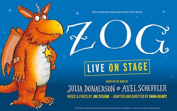 A orange dragon with the words Zog live on stage.