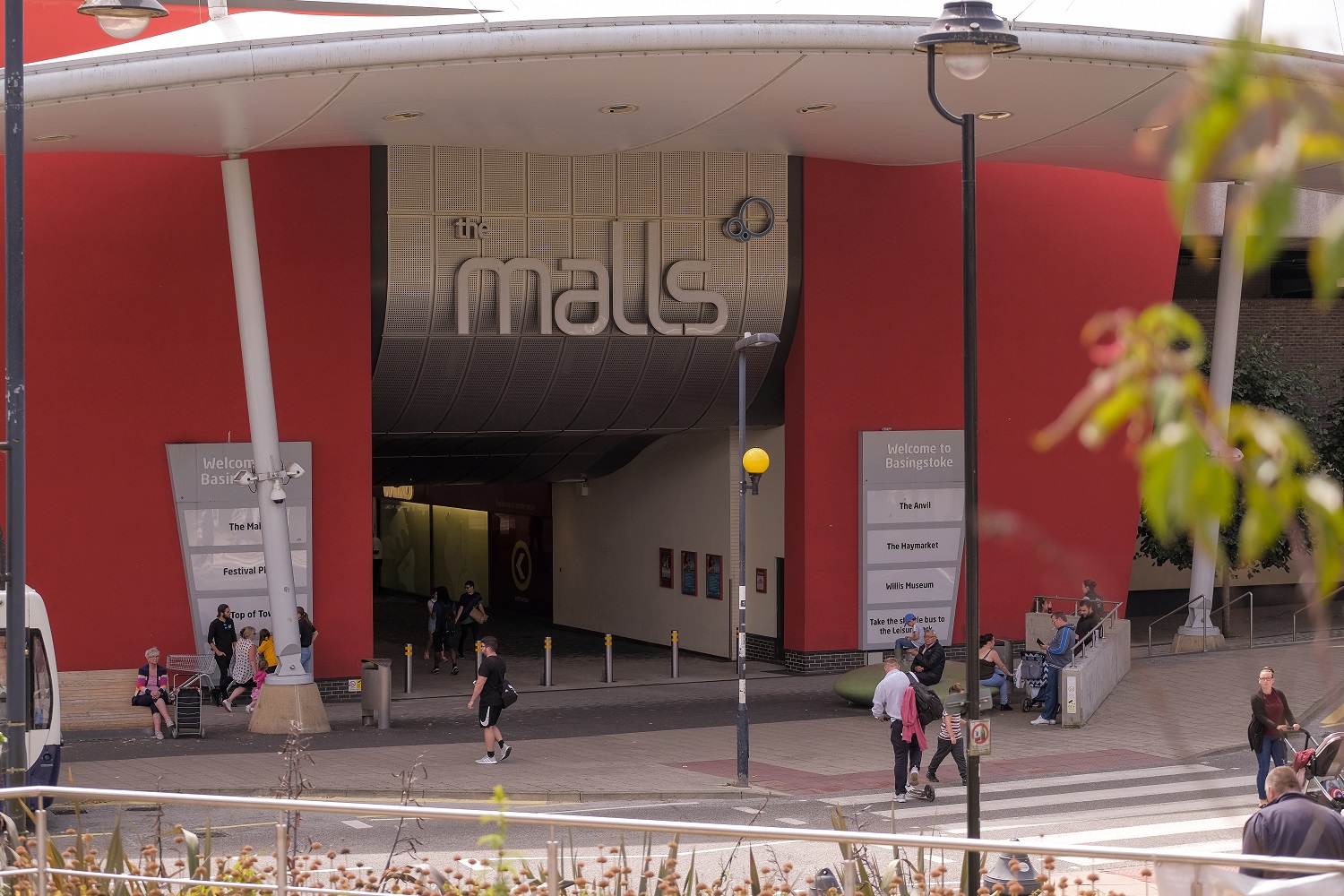 Entrance to the Malls, a red and silver building.