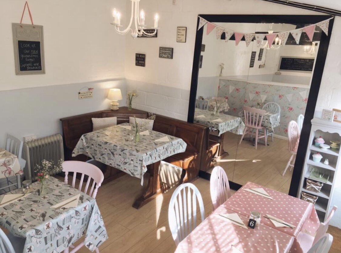 A number of tables set up ready for people.