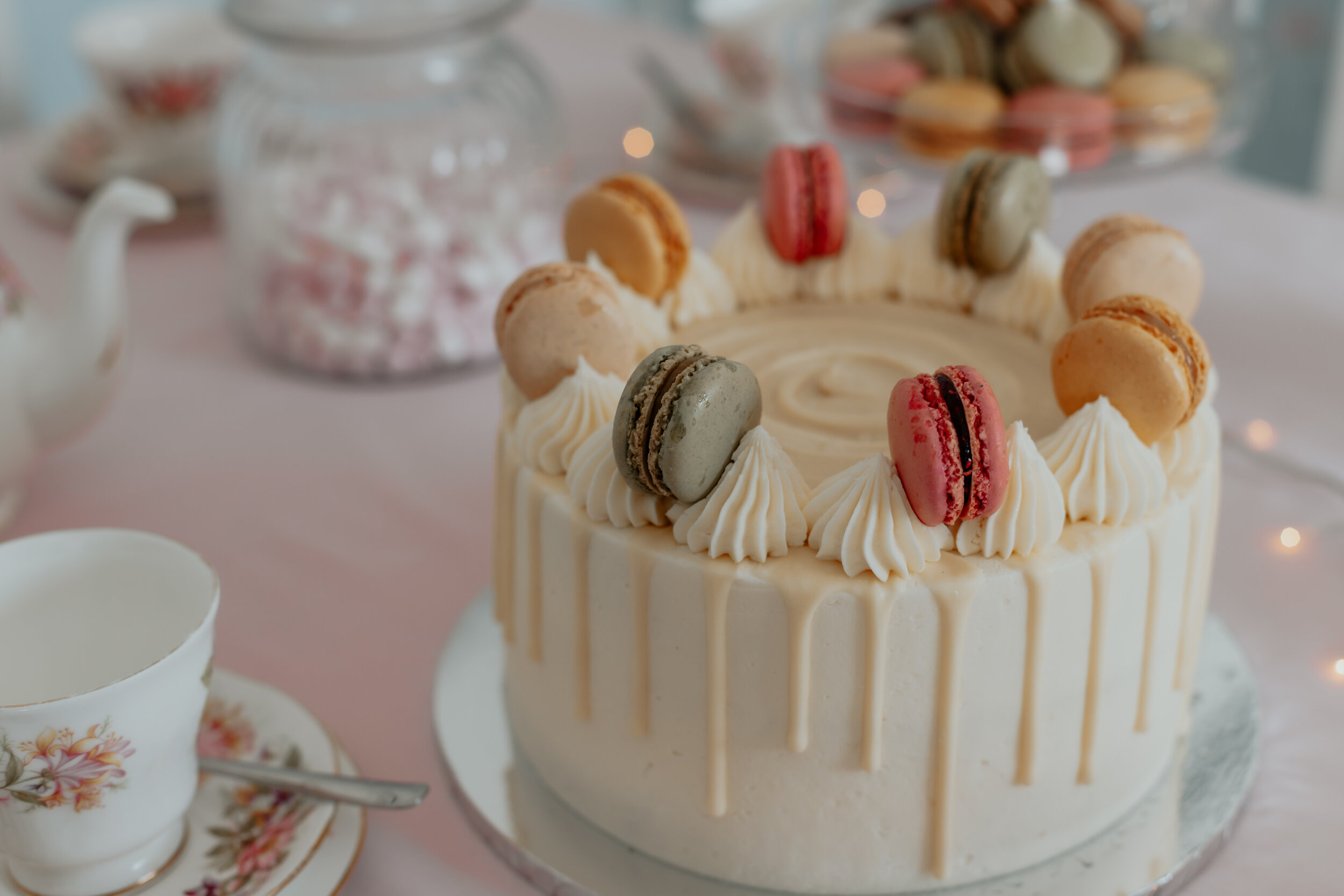 a drip cake with macarons on