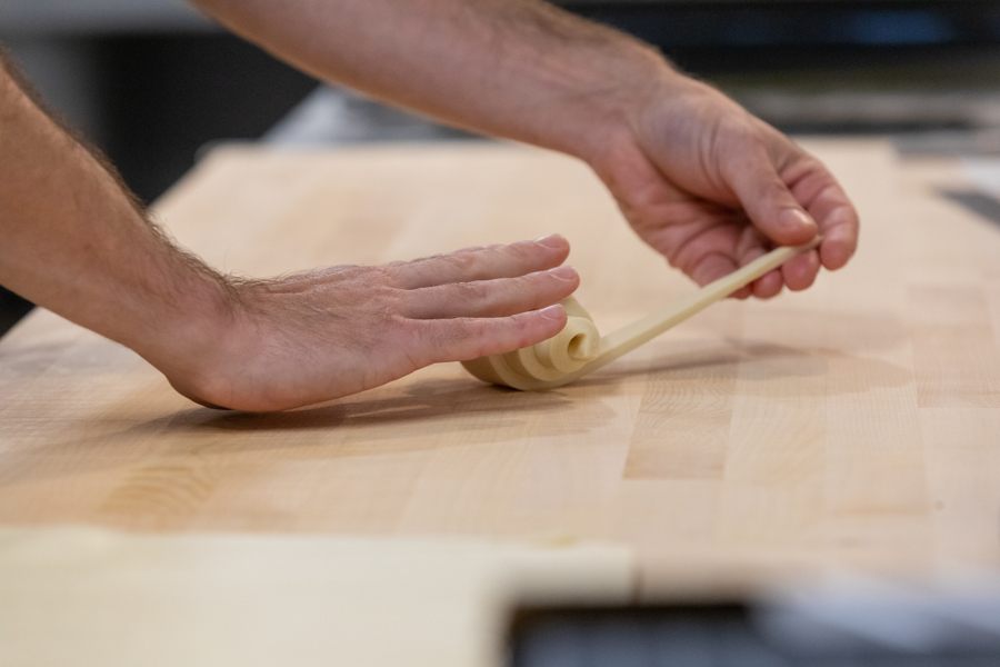 A person making fresh pastries
