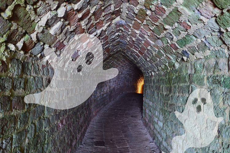 A brick tunnel with ghosts projected onto the sides