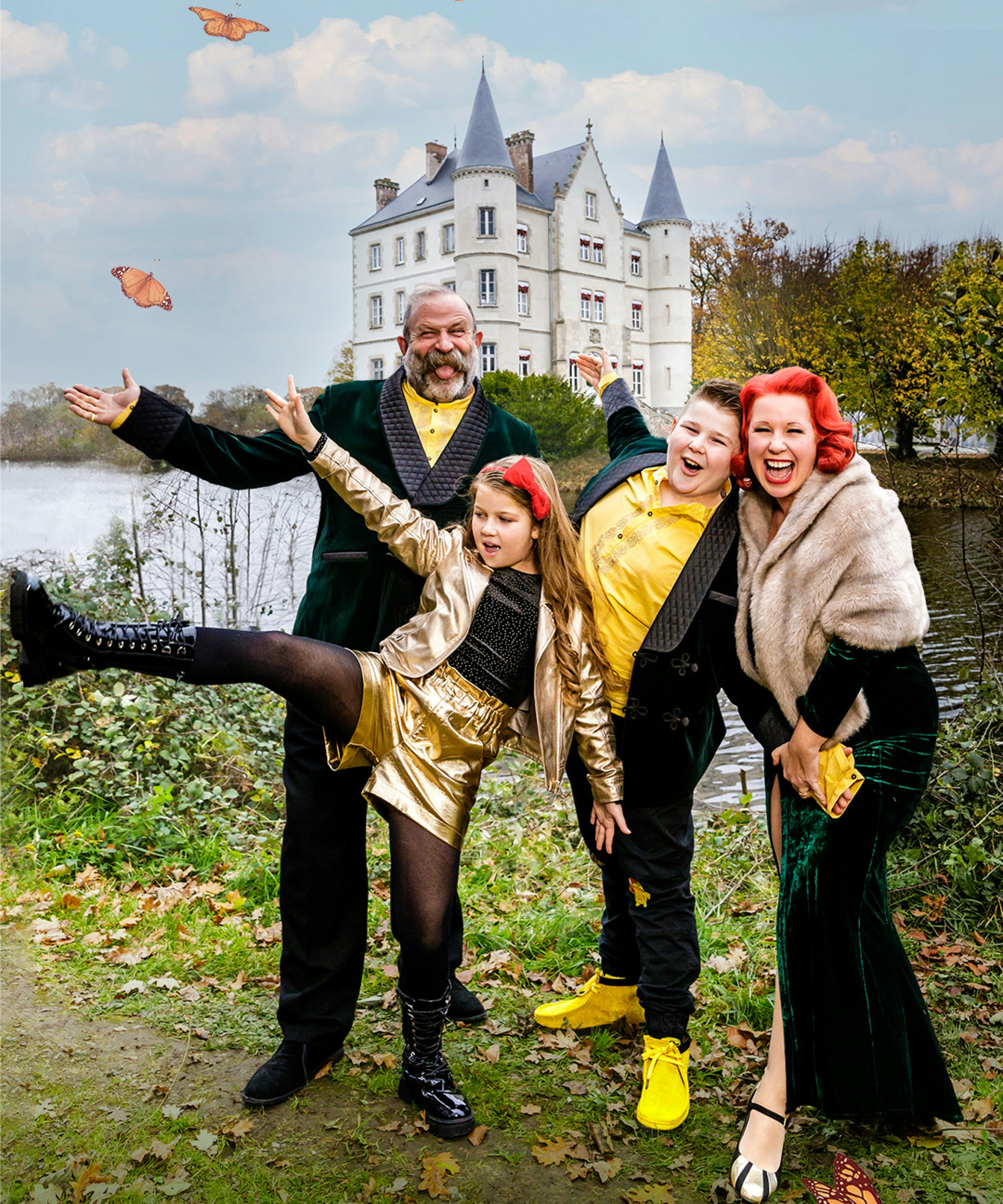 A family of four stand in front of a chateau. They wear yellow, black and gold.