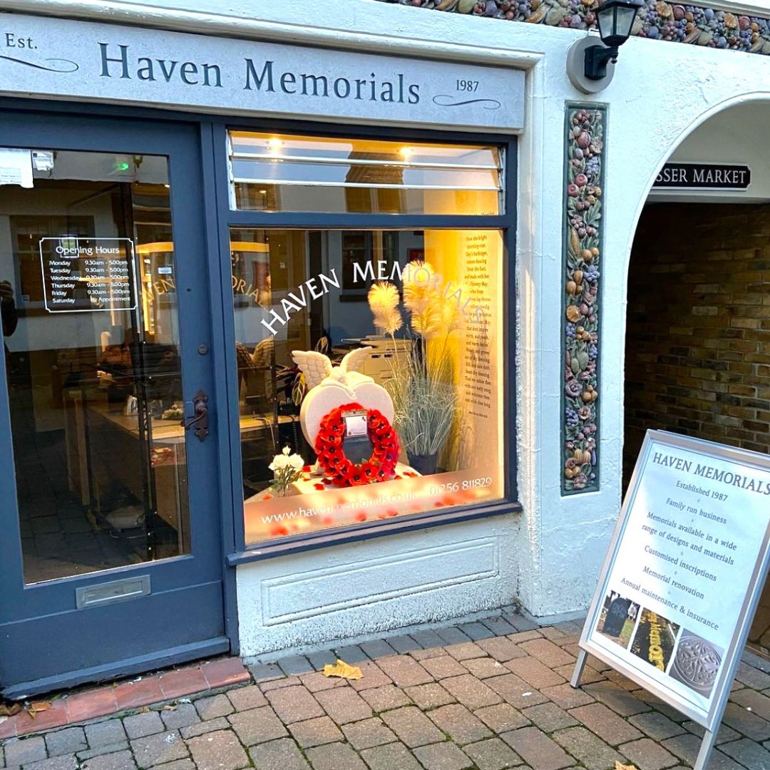 The front of the Haven Memorials Shop at the Top of the Town. You can see a grey door with a large window next to it.