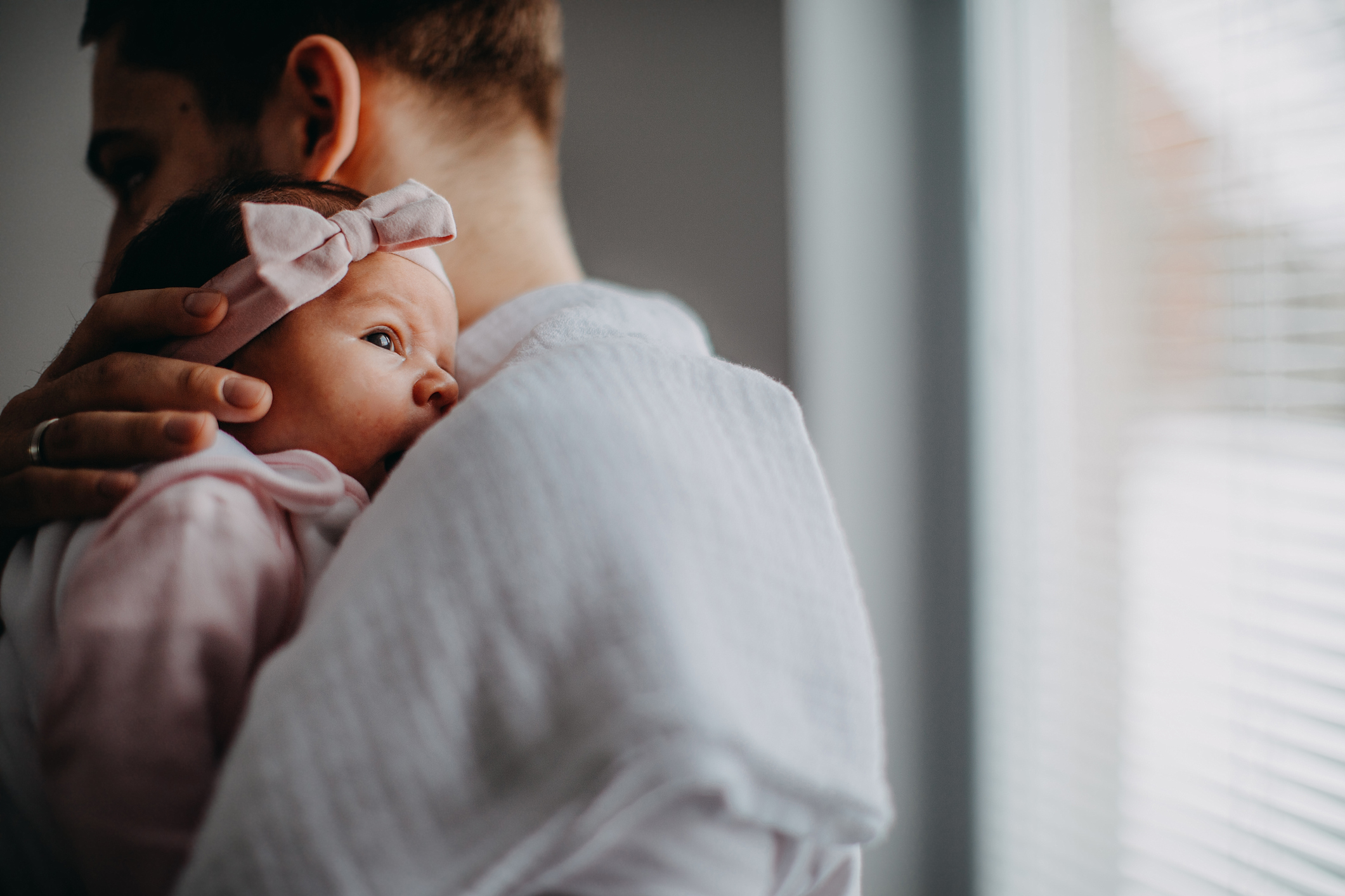 A male holds a young baby