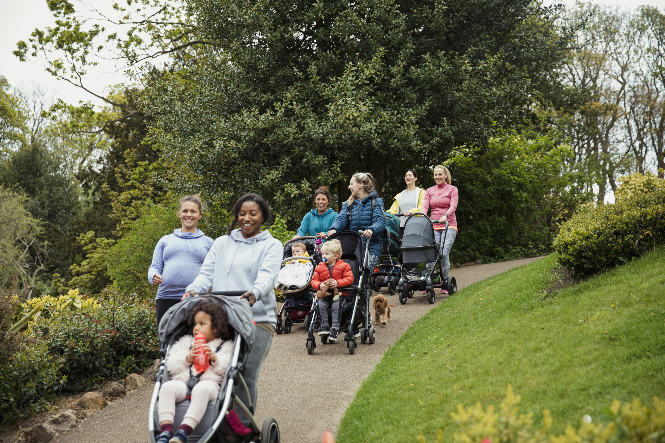 A group of females pushing buggies.