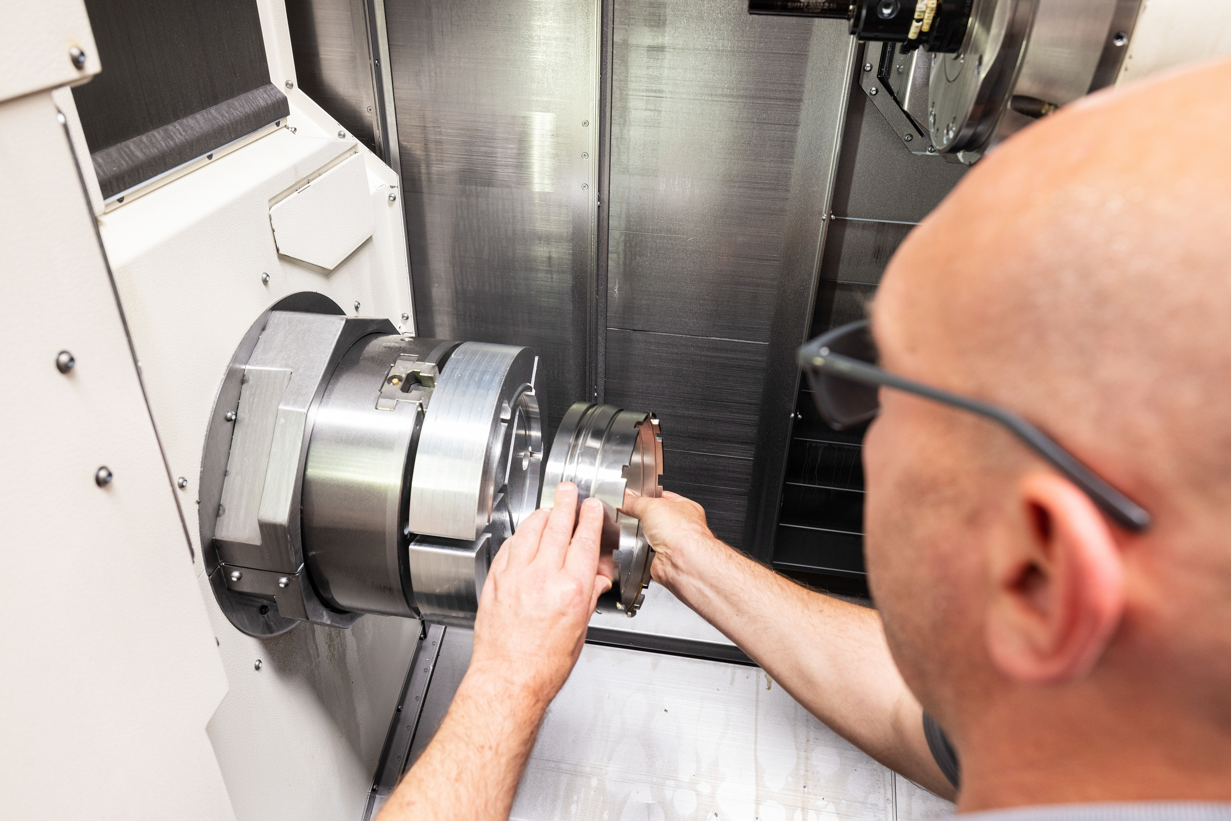 A male works on a machine.