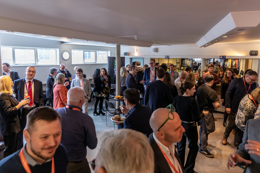 A number of delegates networking.