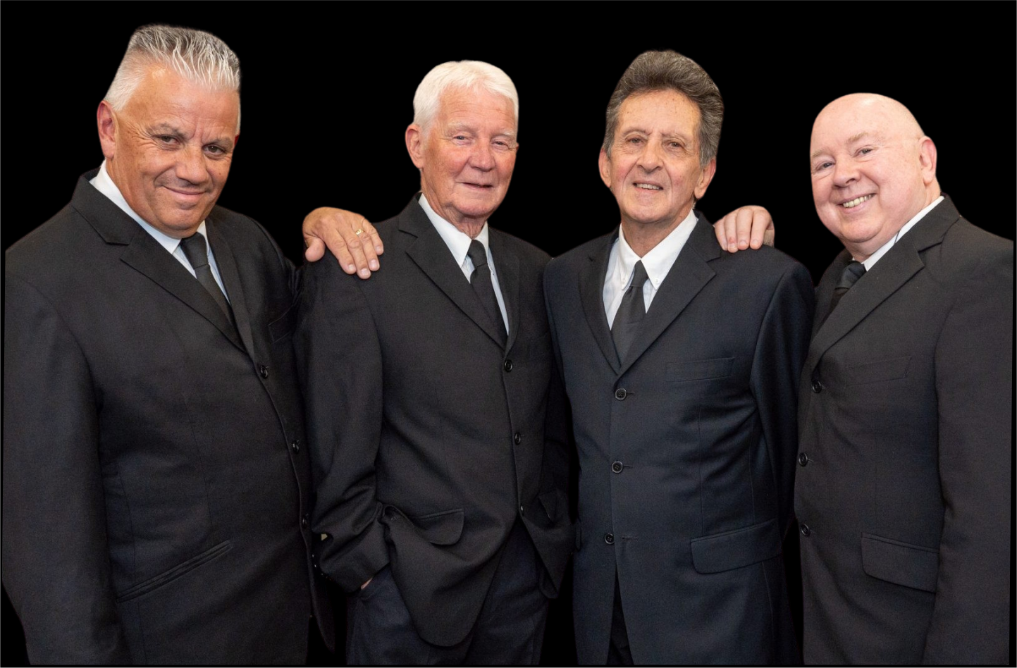 Four men in black tie suits are stood in a row