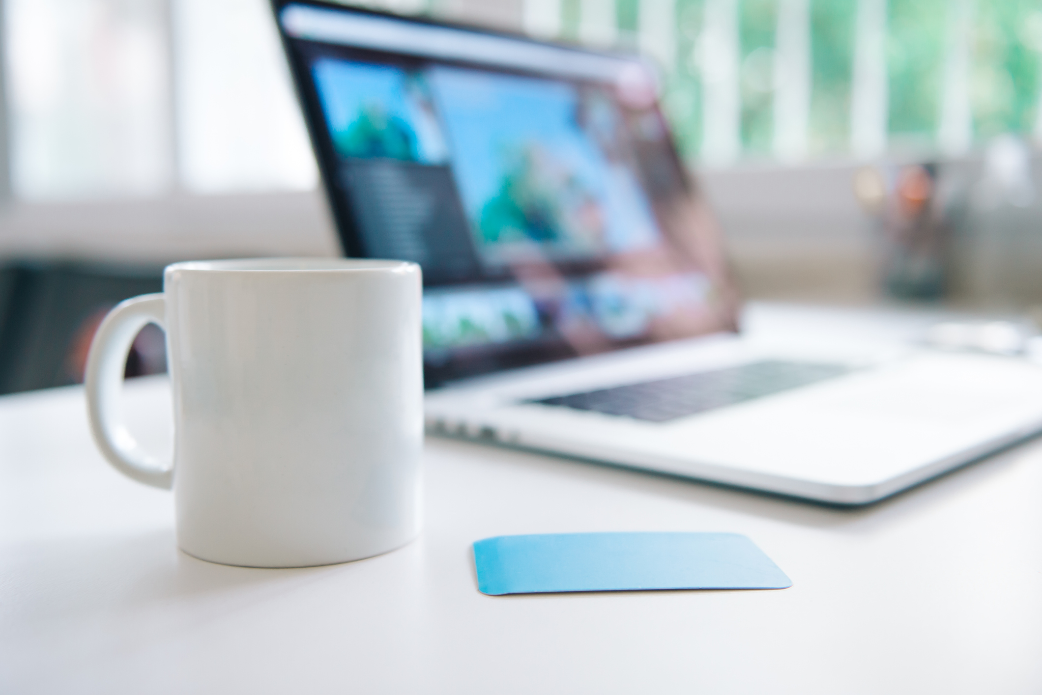 Laptop and a white mug