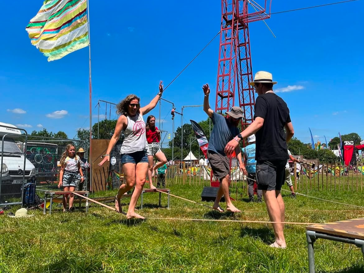 A female walks along the slack line
