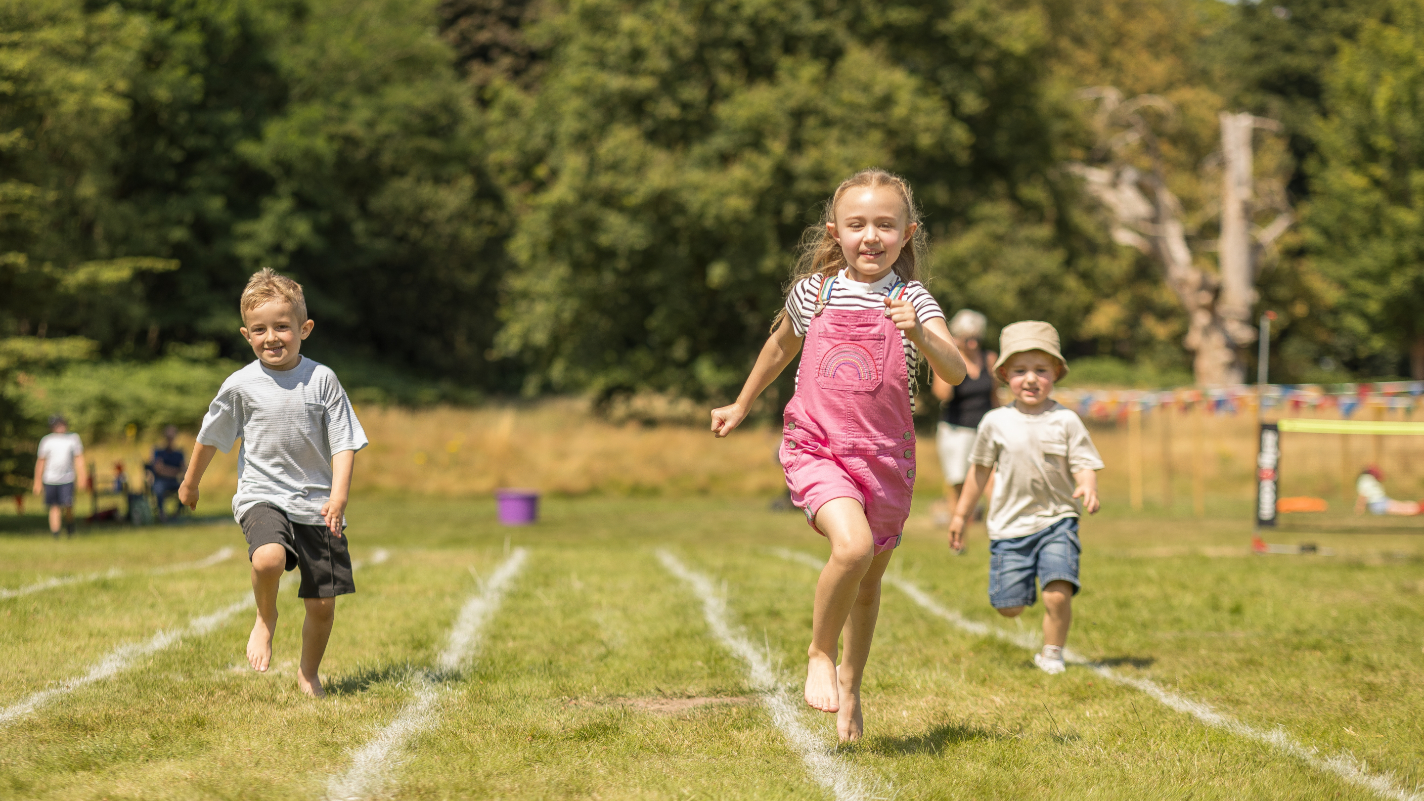 Children running on a grass race track