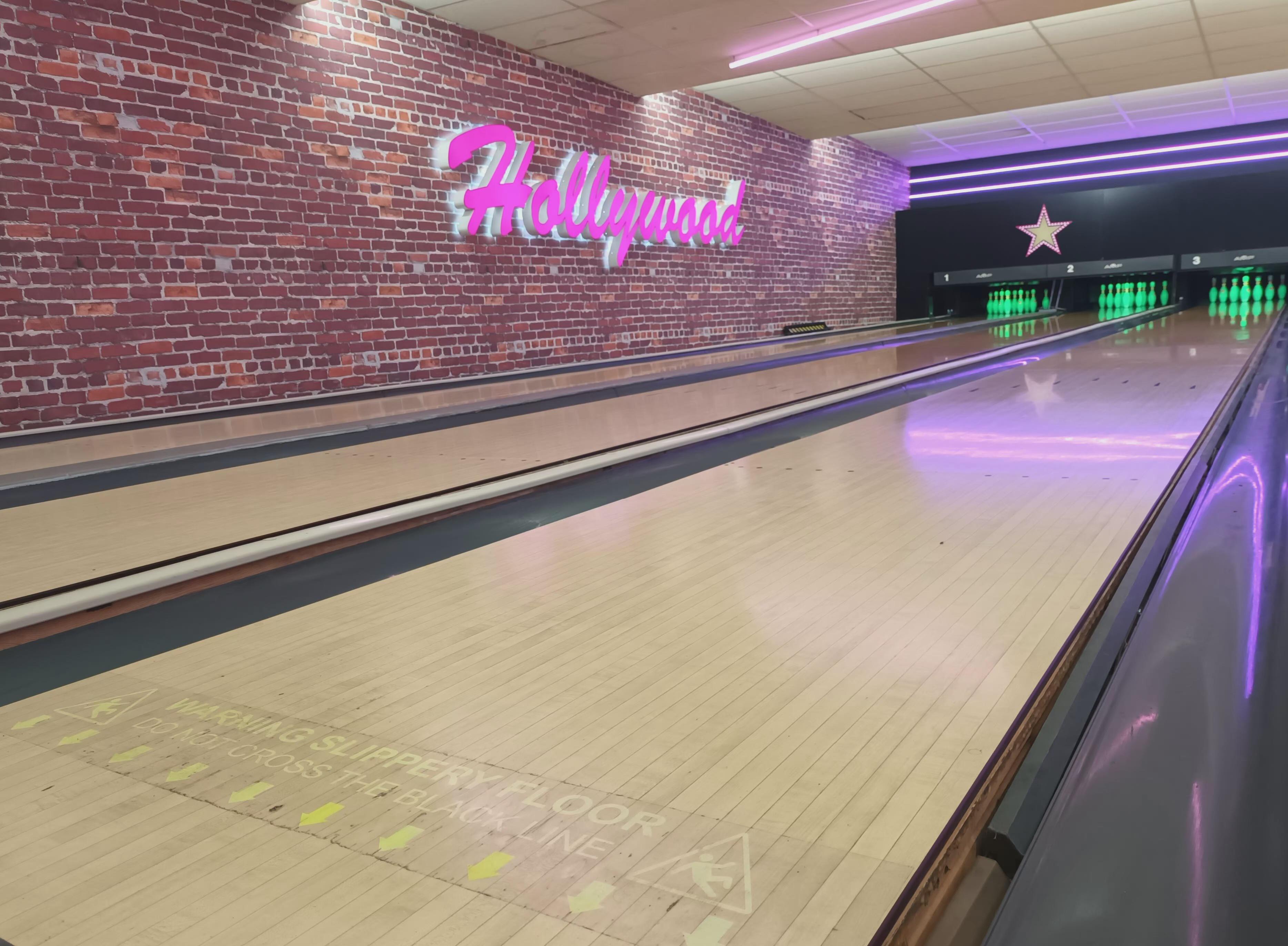 Two bowling lanes with the Hollywood sign.