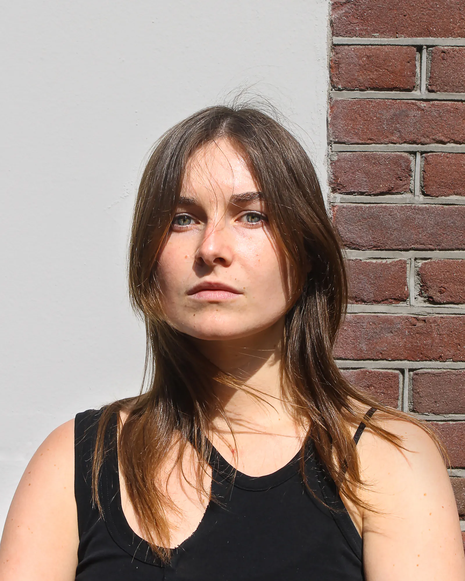 Wonderland team A picture of Grace from Wonderland team with a half brick, half white background