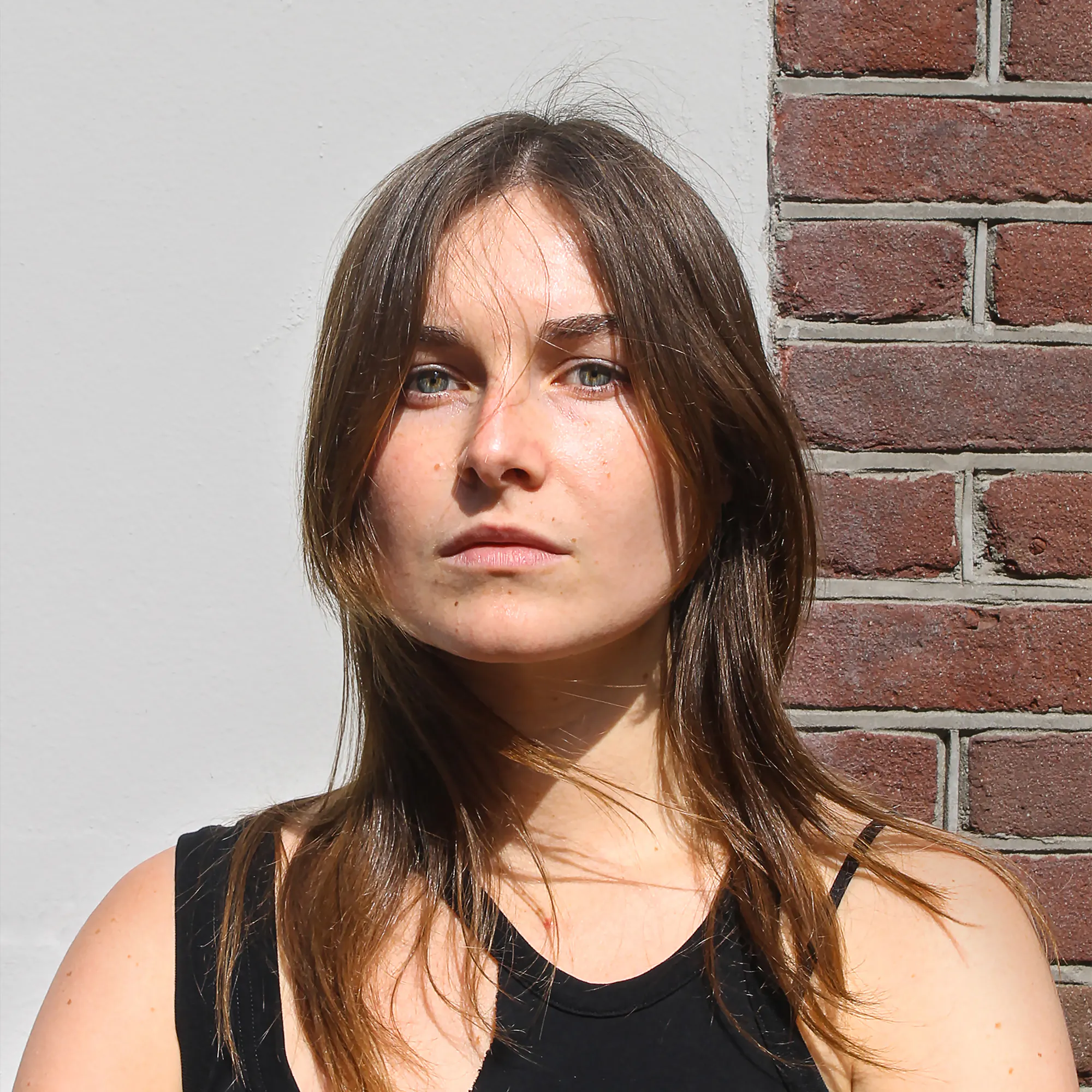 Wonderland team A picture of Grace from Wonderland team with a half brick, half white background