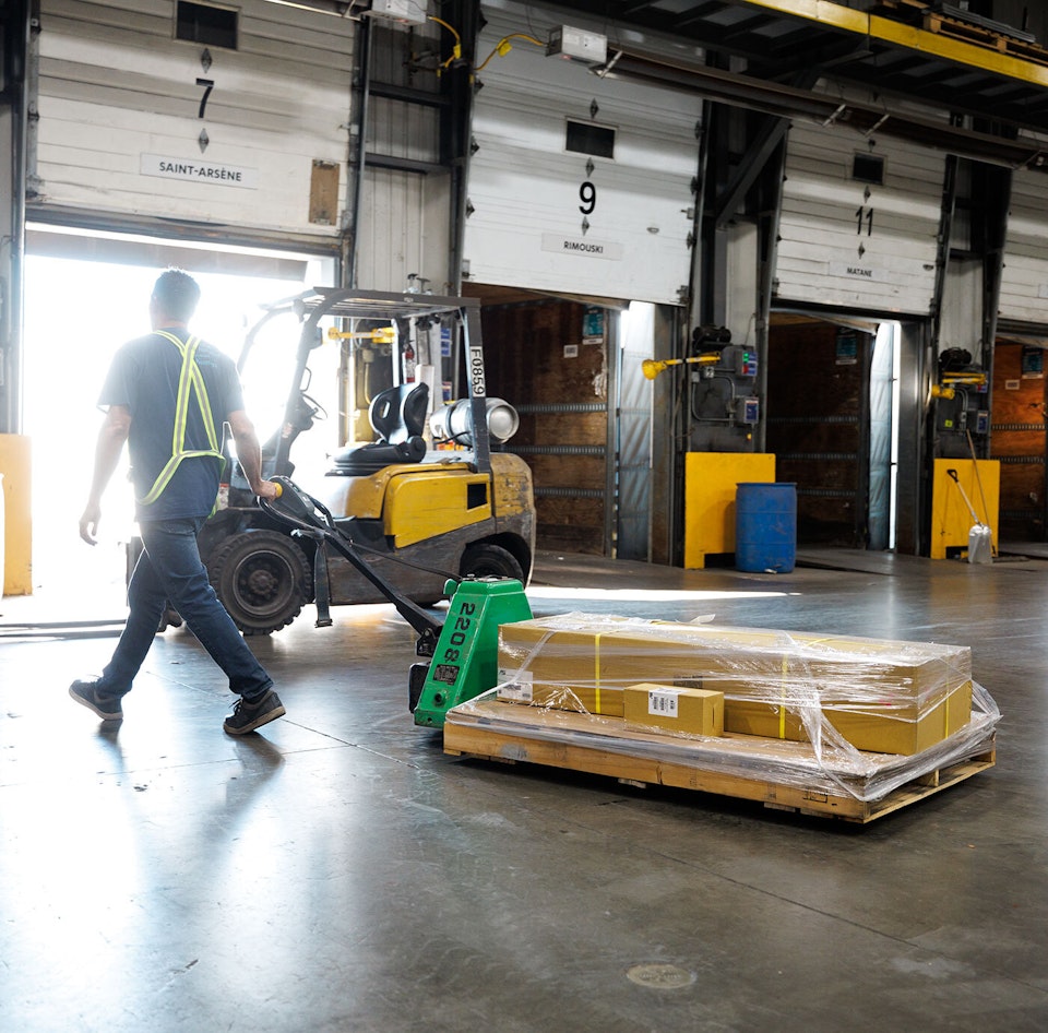 A Groupe Morneau handler moving a pallet on a loading dock.