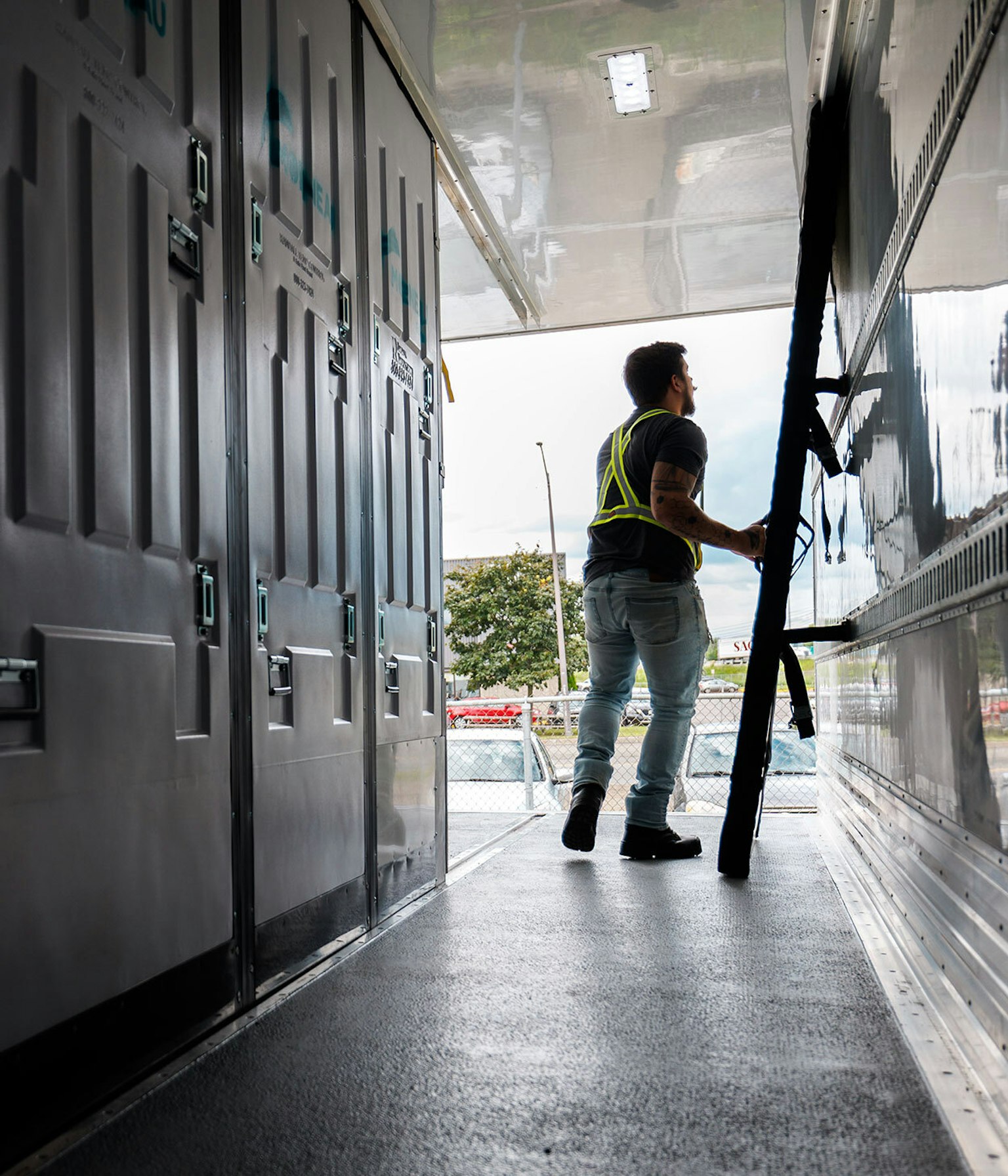 A Groupe Morneau employee rearranges the refrigerated truck’s separators before loading.