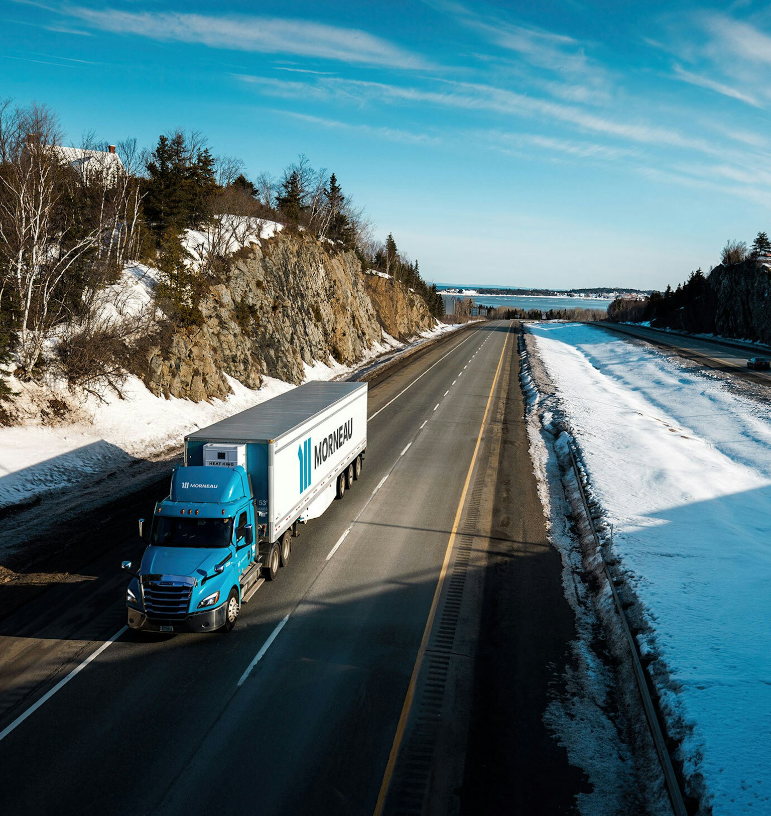 A Groupe Morneau truck, in aerial view, traveling the Quebec’s roads in winter.