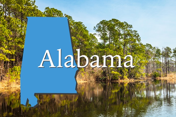 Alabama state outline over an Alabama lake