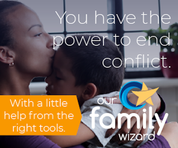 A mother kisses her son on the forehead. OurFamilyWizard promo for the app.