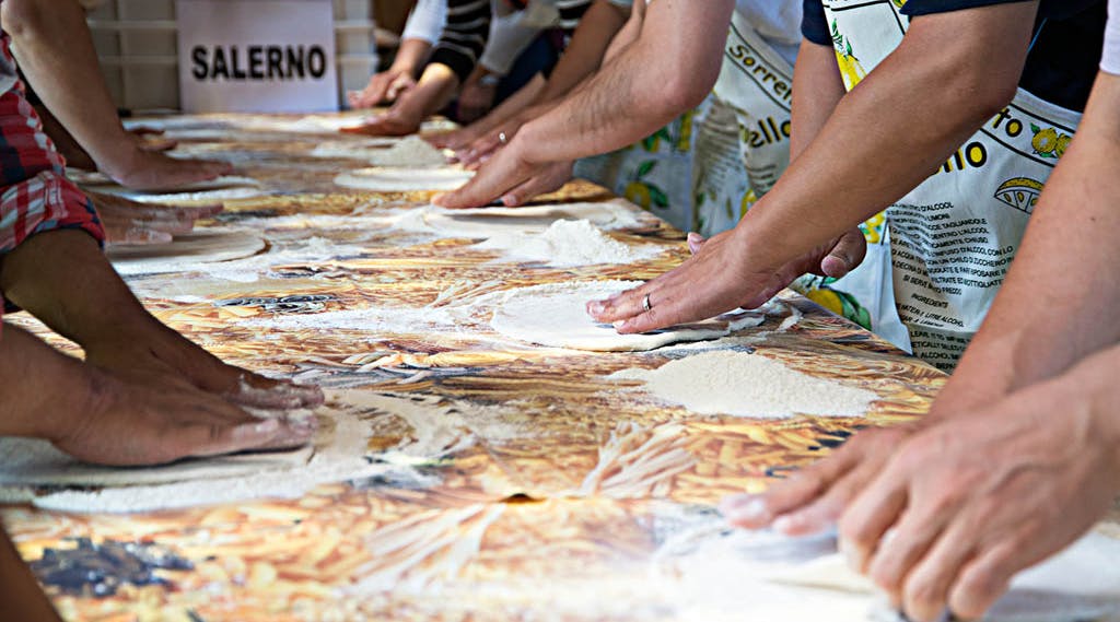 pizza making class hands working on a table
