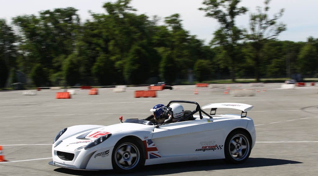 two pilots driving a race car on a closed circuit