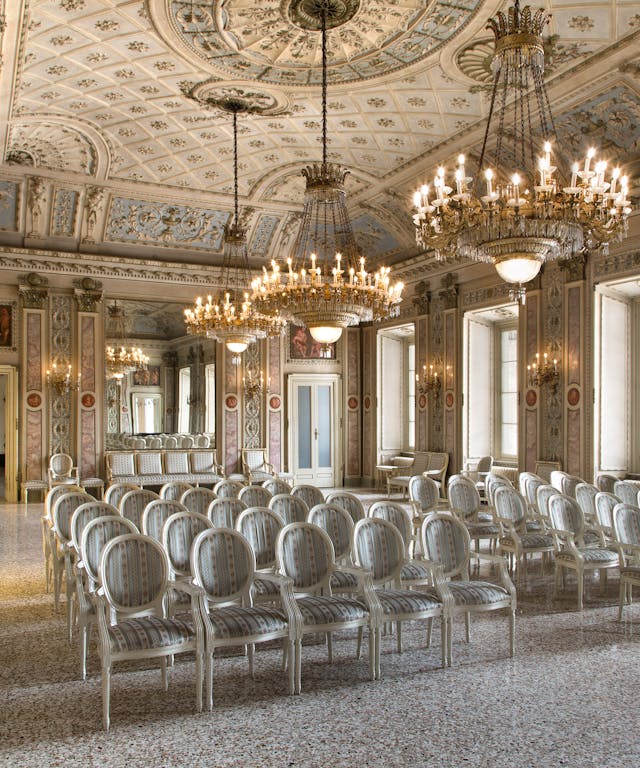 Elegant theater room with frescoed white walls