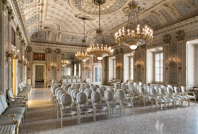 Elegant theater room with frescoed white walls