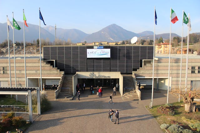 Lariofiere Congress Center with mountains and flags, Lake Como